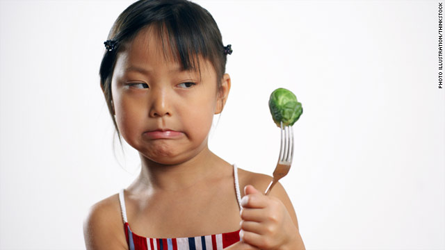 Child making disgusted face at vegtable on fork