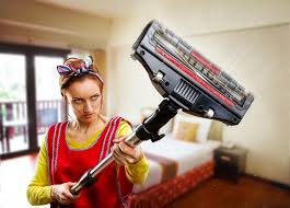 Women holding vacuum cleaner in-air