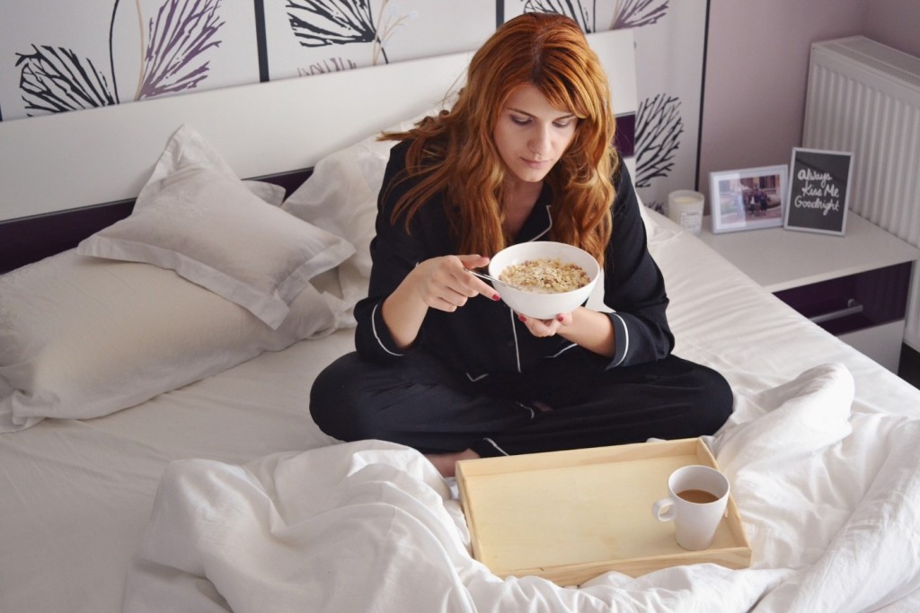 Ill woman eating in bed