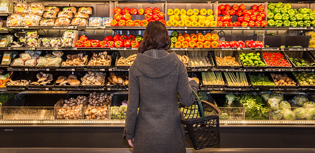 Woman grocery shopping produce area