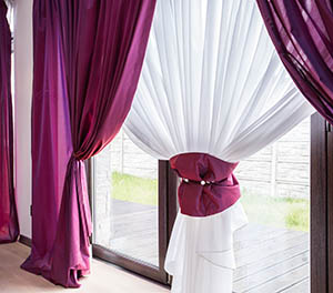 Elegant curtain and purple drapes in luxury residence